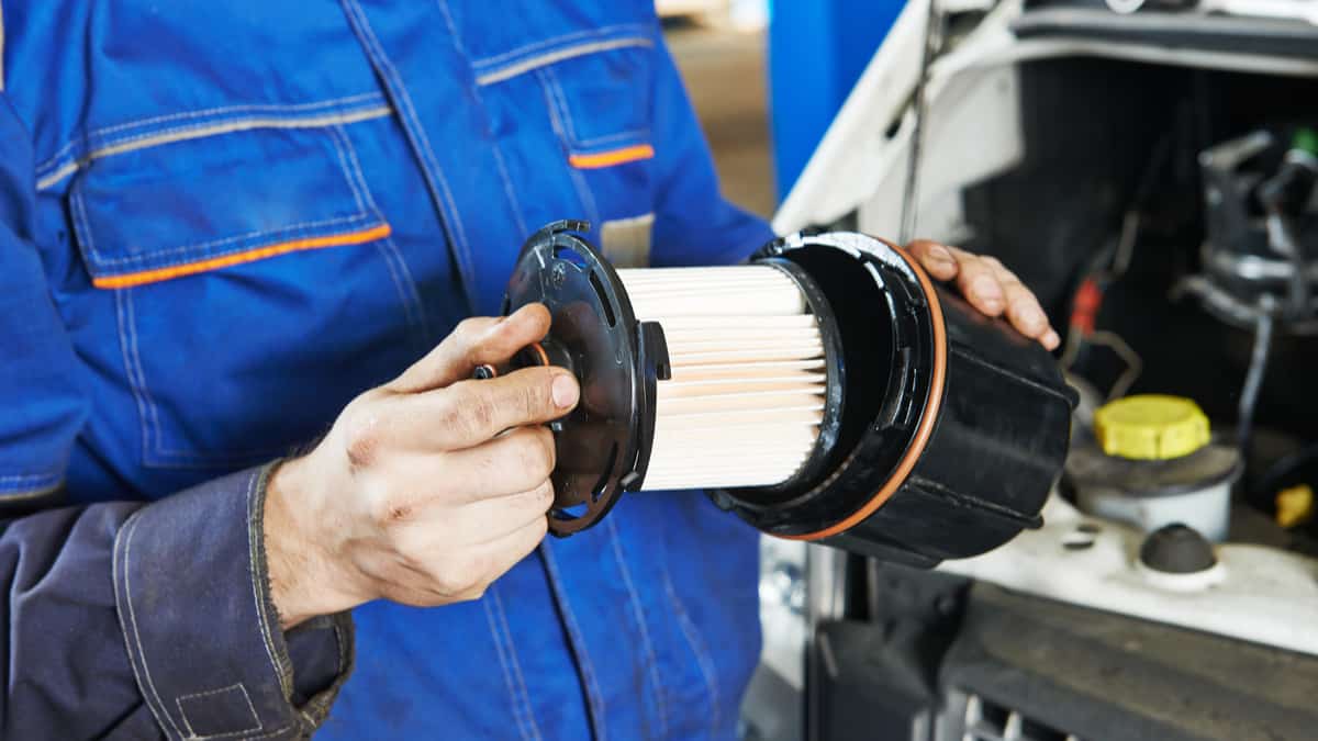 Mechanic checking the condition of a Clark forklift fuel filter